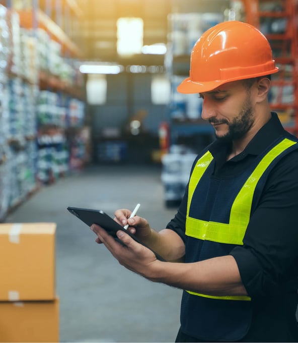 man in hard hat using tablet