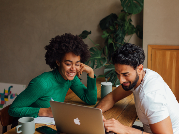 two colleagues looking at a laptop