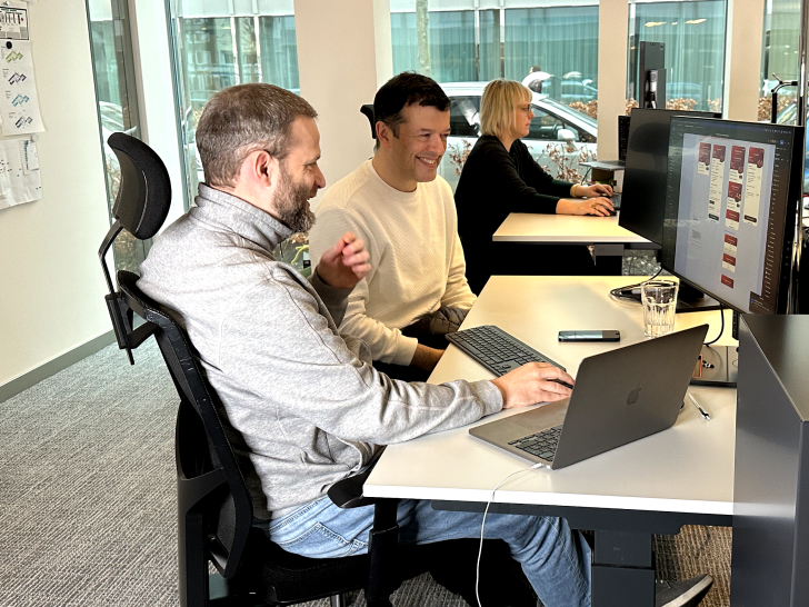 two men working together on a computer