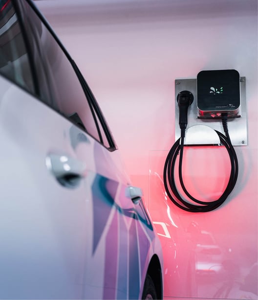 Electric filling device on wall with car standing on the left