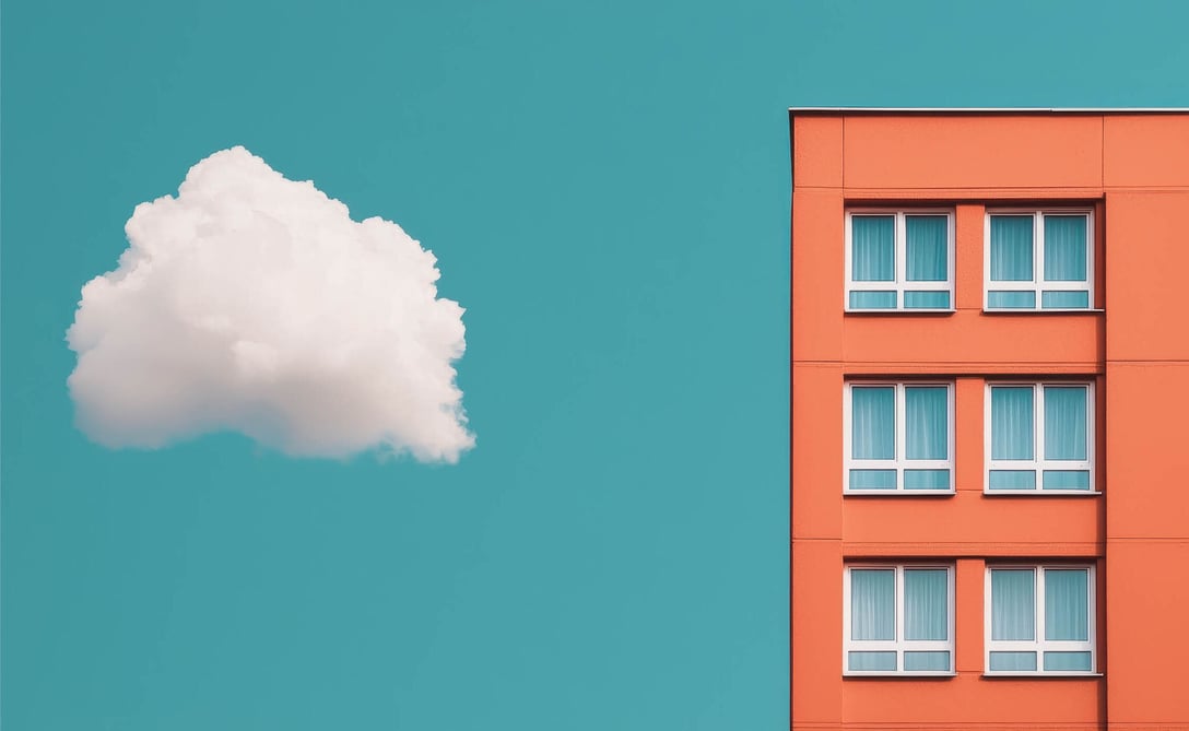 A cloud floating next to a brick house