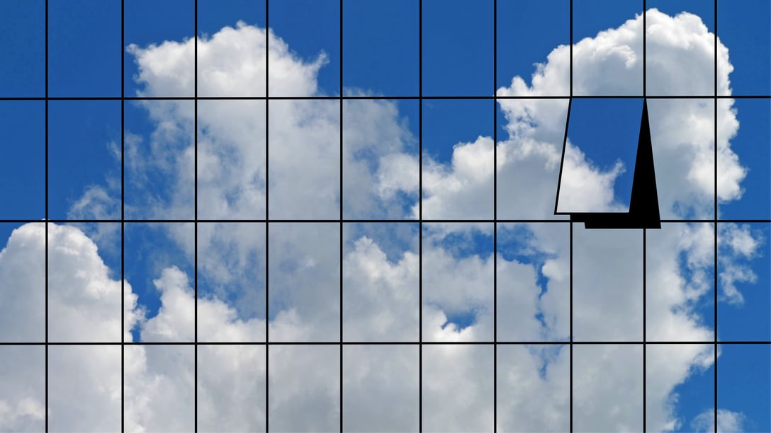 The exterior of a high-rise building mirroring a cloud in the sky
