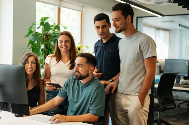 Team collaborating at a work station