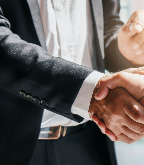 Man in business suit shaking hands with someone 