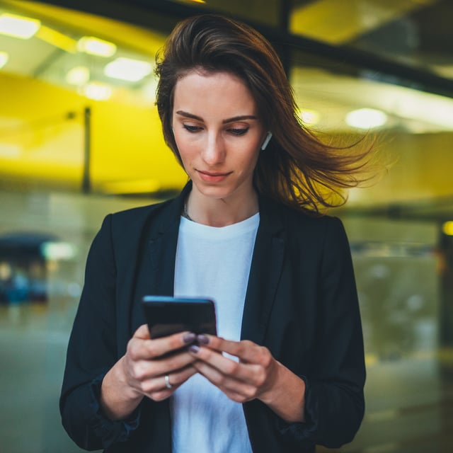 woman looking at her mobile phone