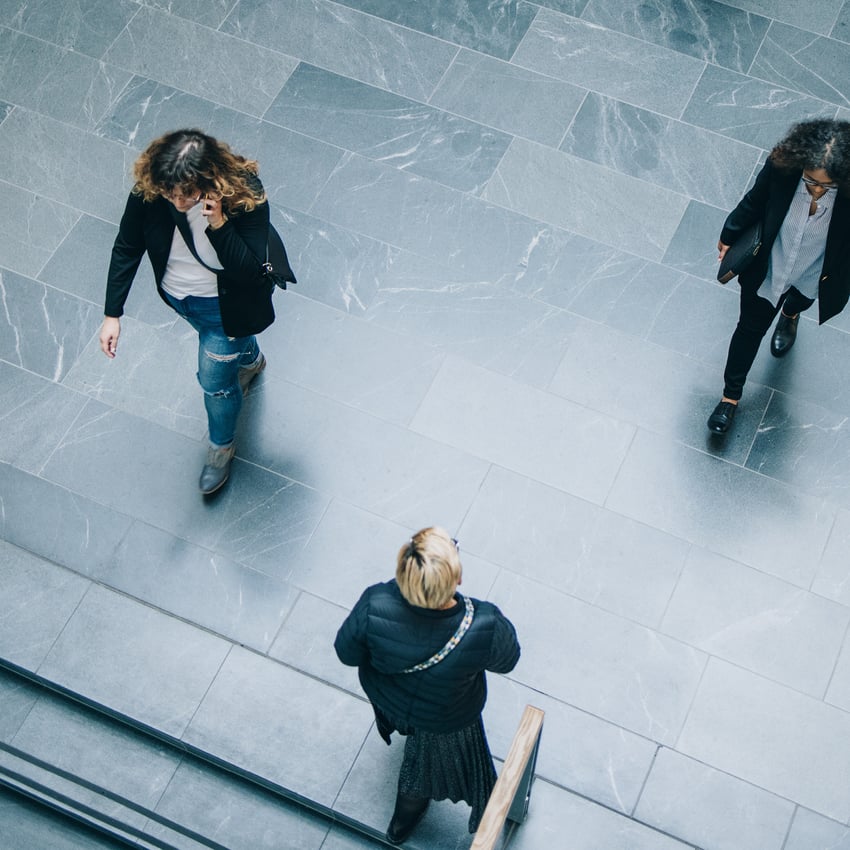 Three people walking seen from bird’s eye perspective 