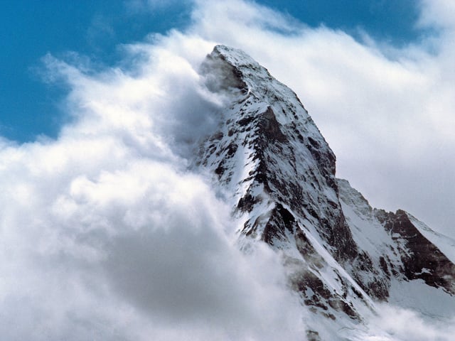 Peak of mountain covered with clouds on the left-hand side 