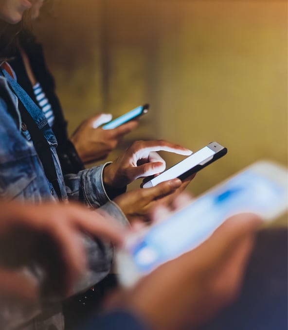 Several people looking at their smartphones 