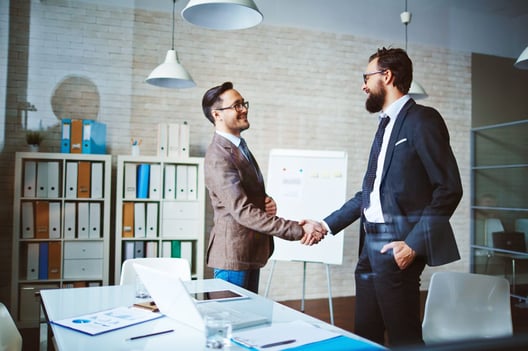 Man in business suit shaking hands with someone 