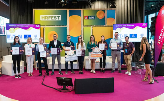 Female and male working colleagues holding up certification 