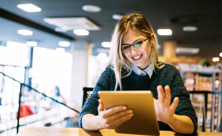 smiling woman with tablet in her hands