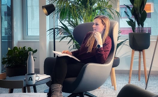 Adnovum employee sitting in wing chair being interviewed  