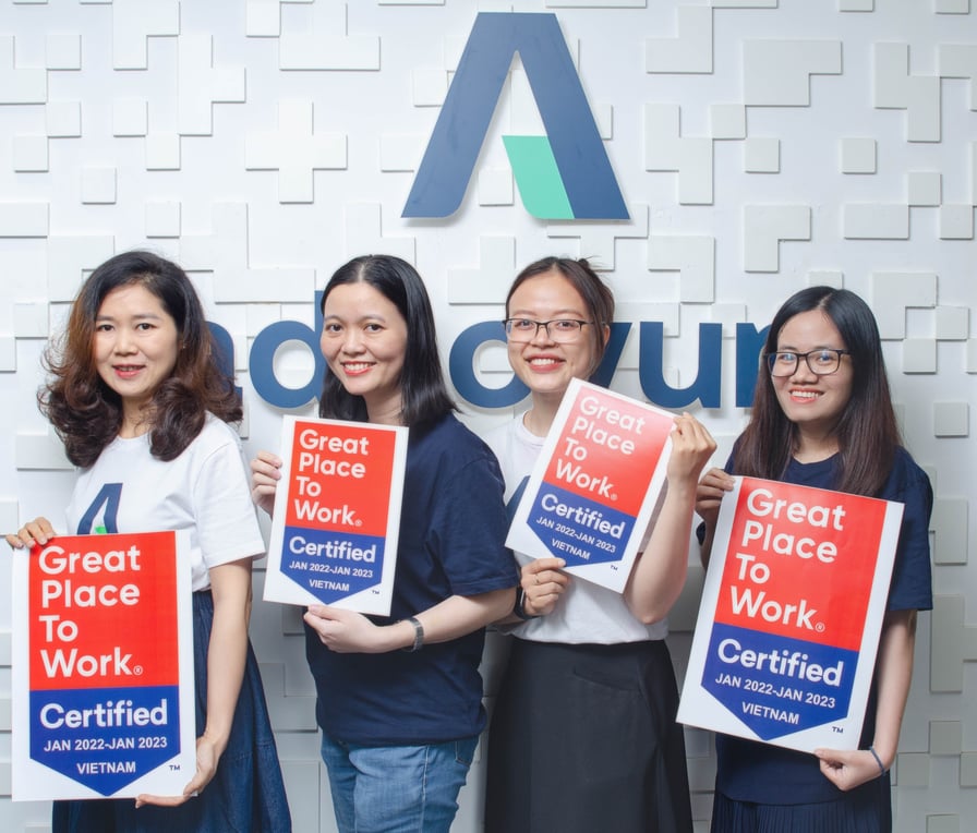 Female working colleagues at Adnovum Vietnam holding up certification 
