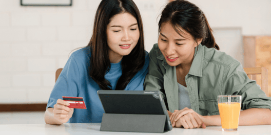 2 people using a digital device for online shopping