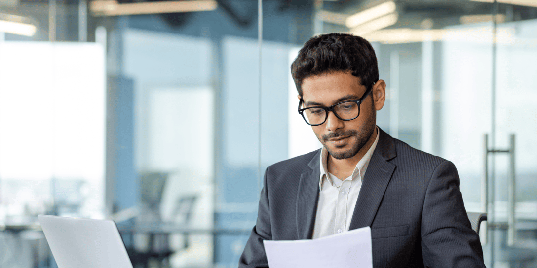 Businessman working by the desk and reading documents.