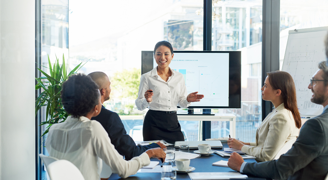 a woman is presenting in a meeting