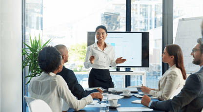 a woman is presenting in a meeting