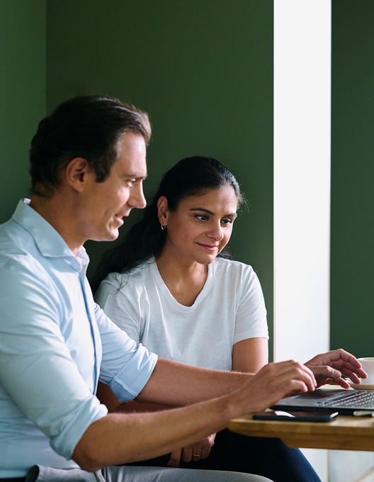 Two colleagues working on a laptop