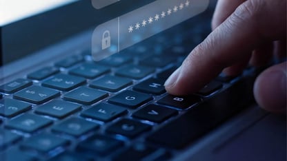 finger on a keyboard typing password 
