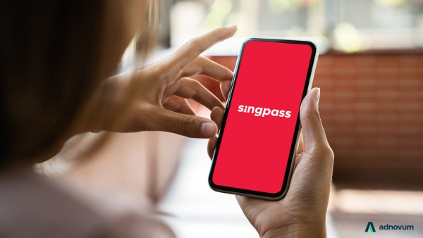 Person holding smartphone showing SingPass app on screen 