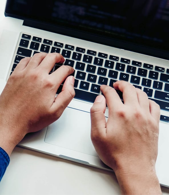Hands writing on laptop